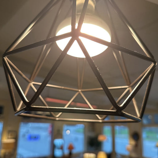 Geometric pendant light fixture with a blurred indoor background