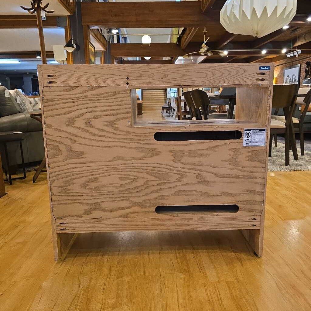 Wooden cabinet on a wooden floor with a blurred background