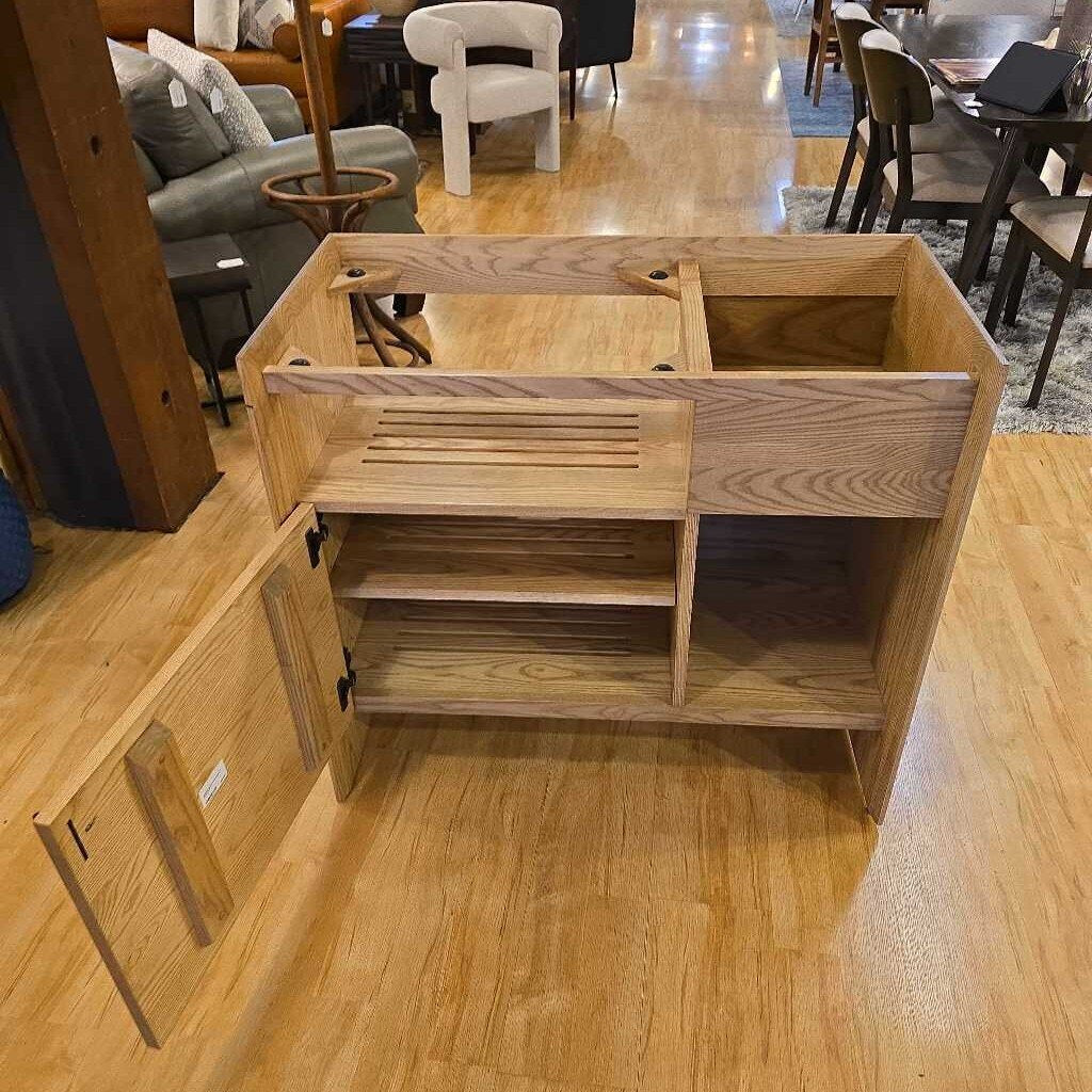 Wooden cabinet with open doors on a wooden floor