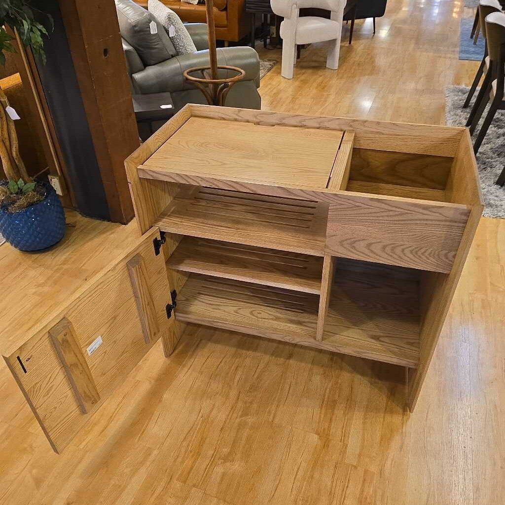 Wooden cabinet with open doors on a wooden floor