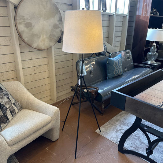 Living room with a sofa, armchair, coffee table, and lamp.
