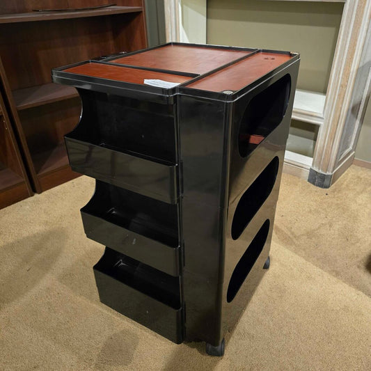 Black and brown storage unit on a carpeted floor