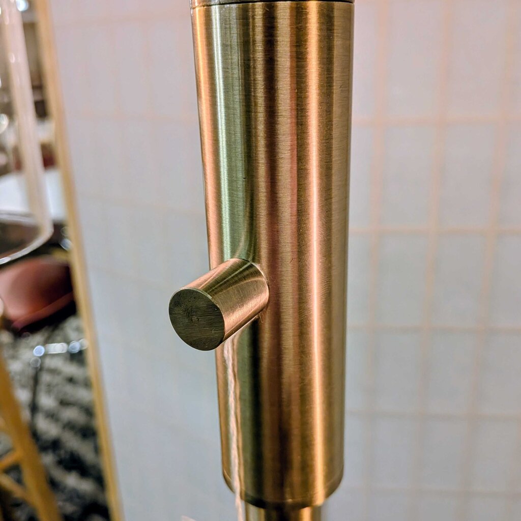 Close-up of a gold handle on a door with a blurred background