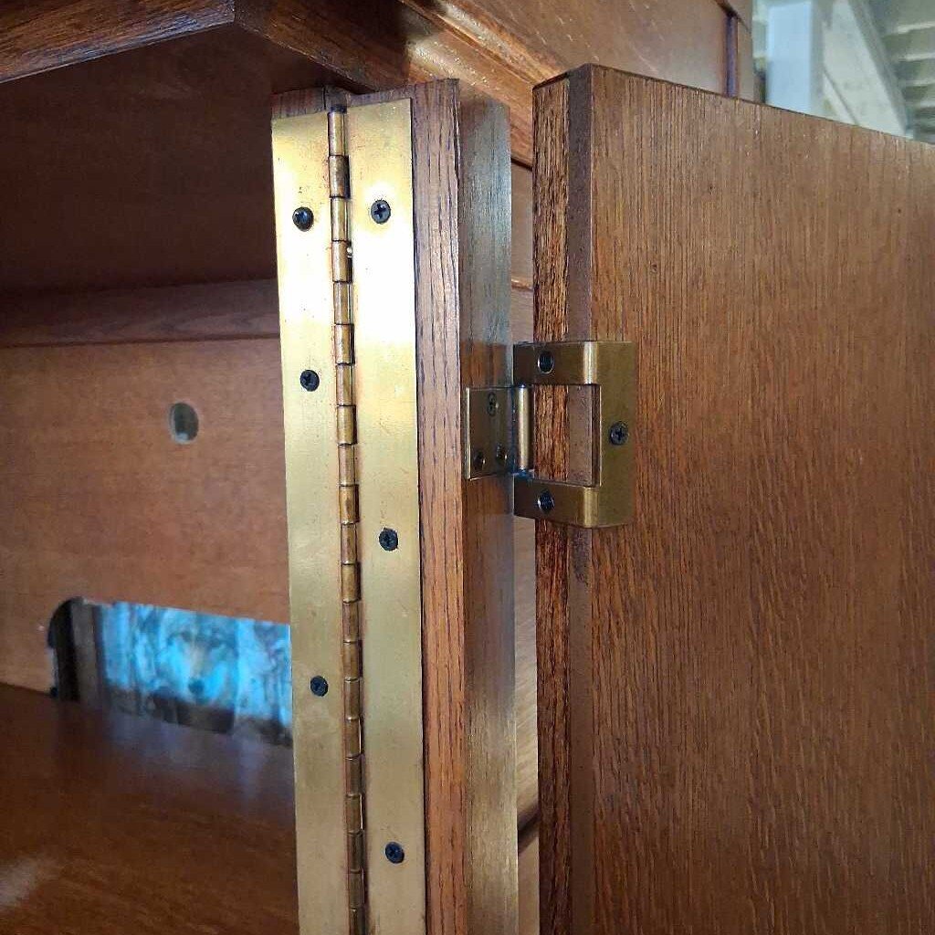 Wooden cabinet with brass hinges and hardware