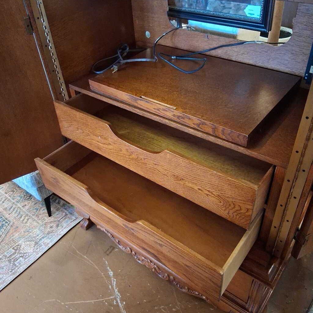 Wooden desk with open drawers in a room setting