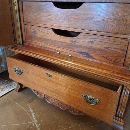 Wooden dresser with open drawer on a marble floor