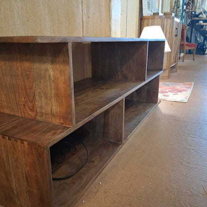 Wooden shelf unit in a room with a carpeted floor