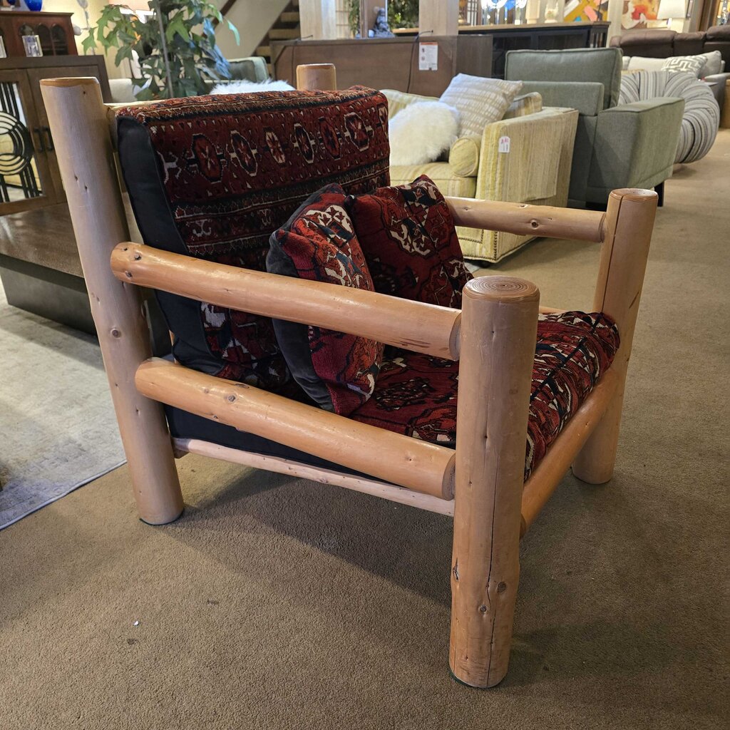 Wooden chair with patterned cushions in a furniture store setting