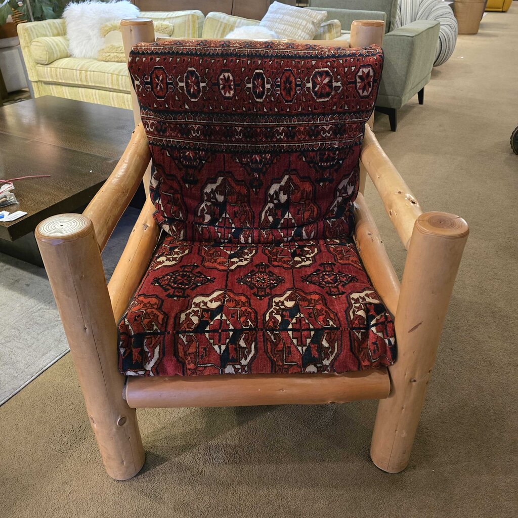 Wooden chair with patterned red cushion in a room setting