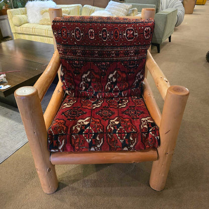 Wooden chair with patterned red cushion in a room setting