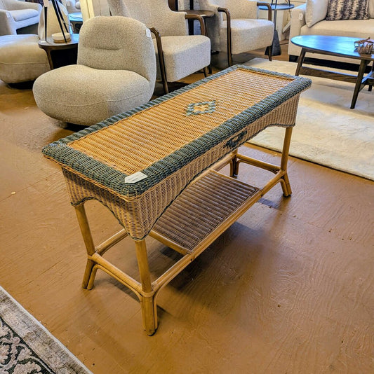 Wicker coffee table with a woven top in a room with furniture