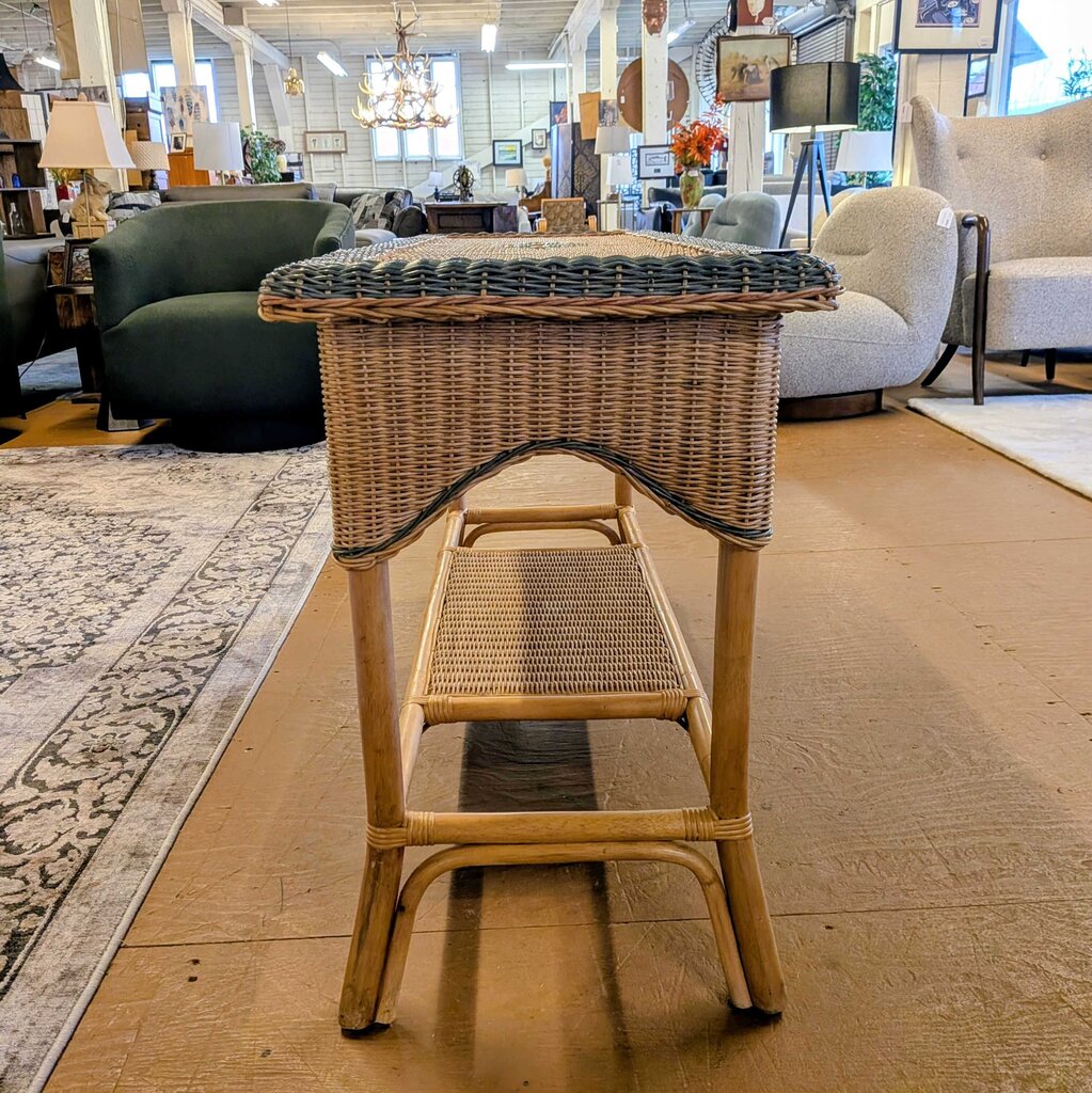 Wicker side table with a woven top and bench in a furniture store setting