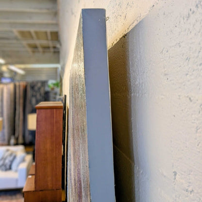 Close-up of a textured wall with a blurred indoor setting in the background