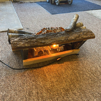 Wooden fire pit with glowing interior on a concrete floor