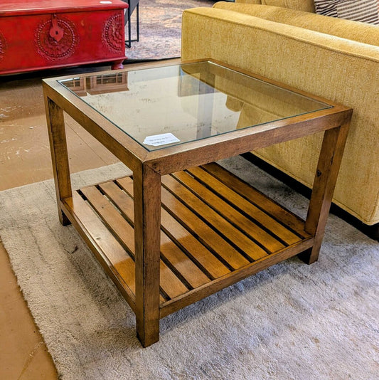 Wooden coffee table with glass top in a room setting