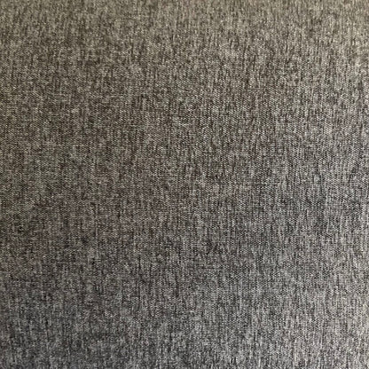 Gray sofa in a showroom with other furniture and decor items.