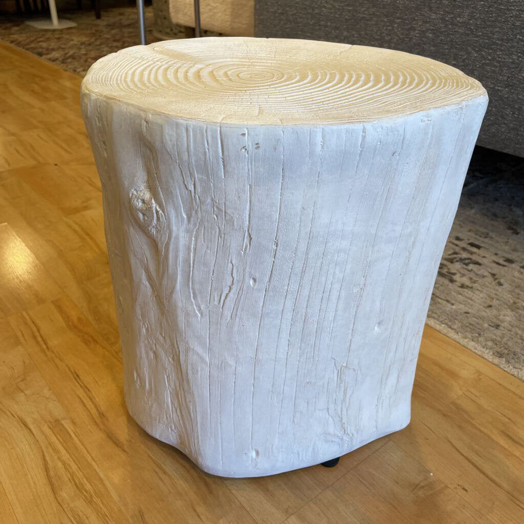 Wooden stool with a white-painted base on a wooden floor