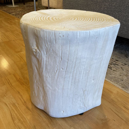 Wooden stool with a white-painted base on a wooden floor