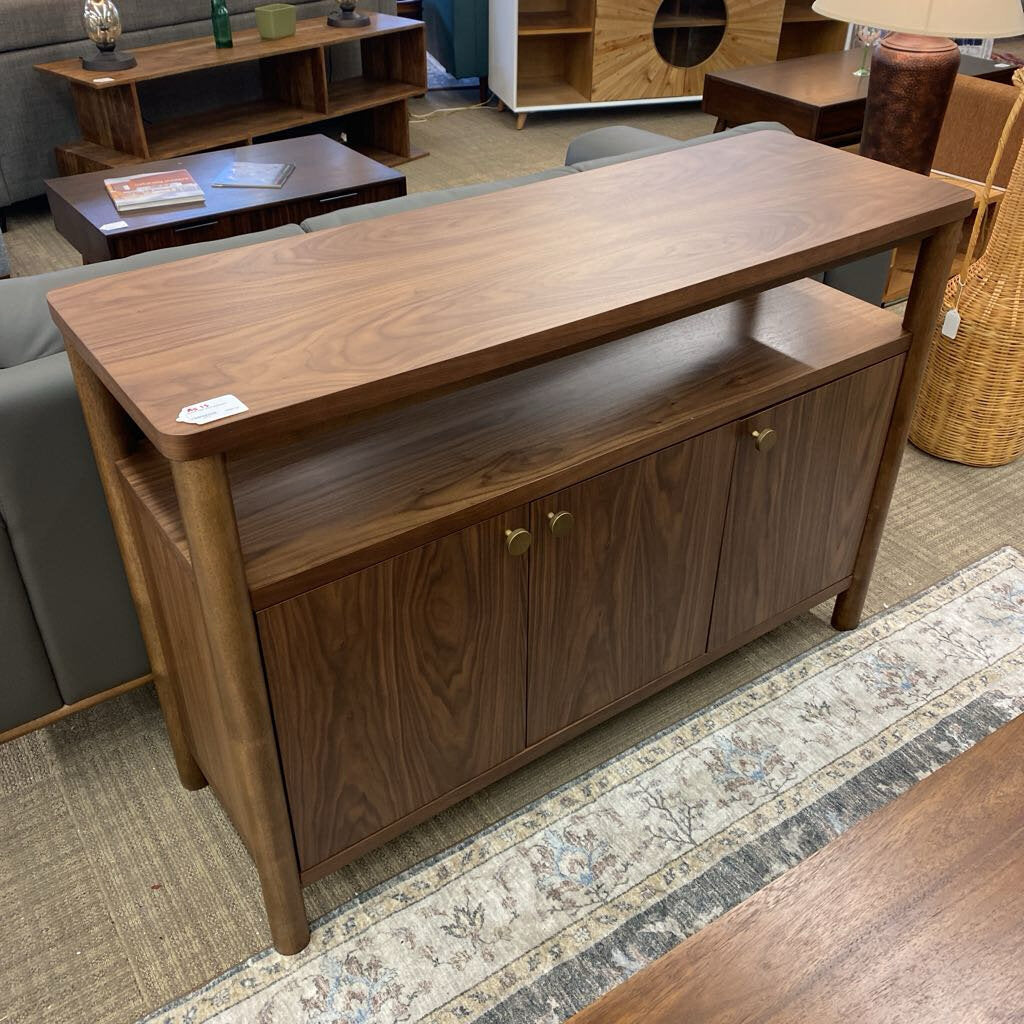 Wooden console table with storage cabinets in a room setting