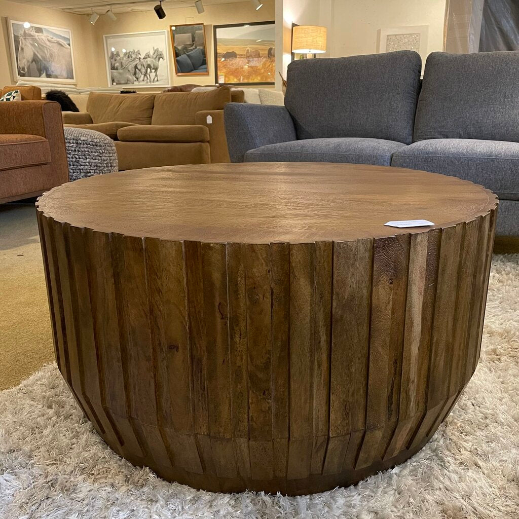 Wooden coffee table in a showroom with furniture and decor in the background