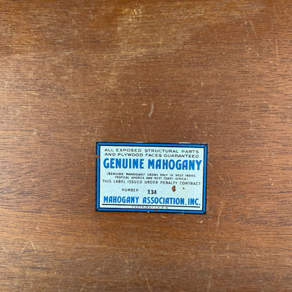 Genuine Mahogany label on a wooden surface