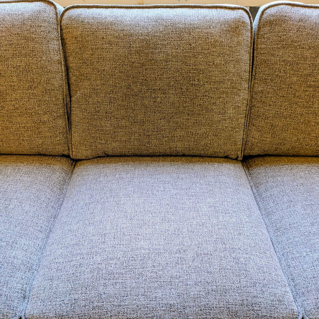 Beige fabric sofa with a textured pattern