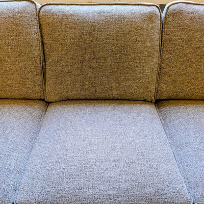 Beige fabric sofa with a textured pattern