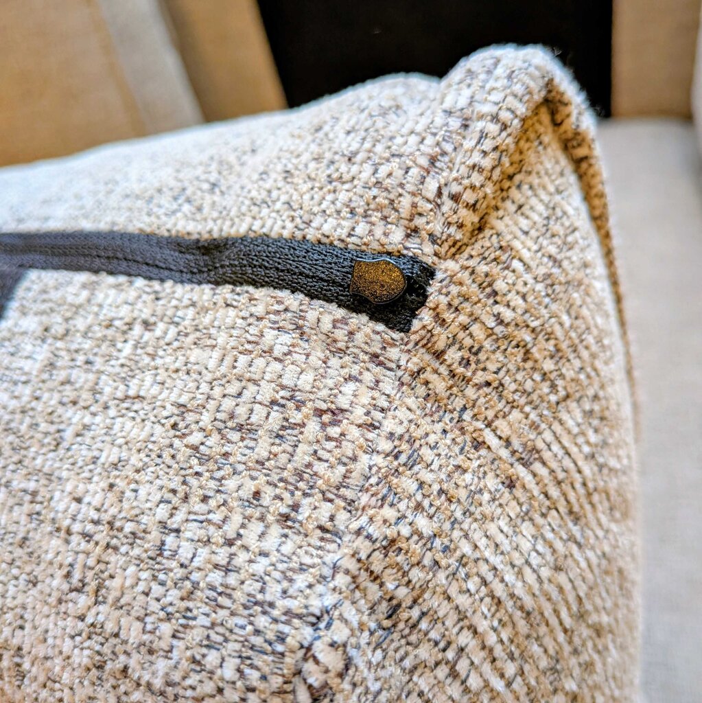 Textured fabric with a button detail on a neutral background