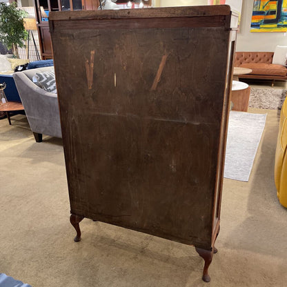 Wooden cabinet in a room with furniture and decor