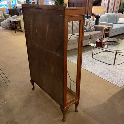 Wooden display cabinet in a room with furniture and decor