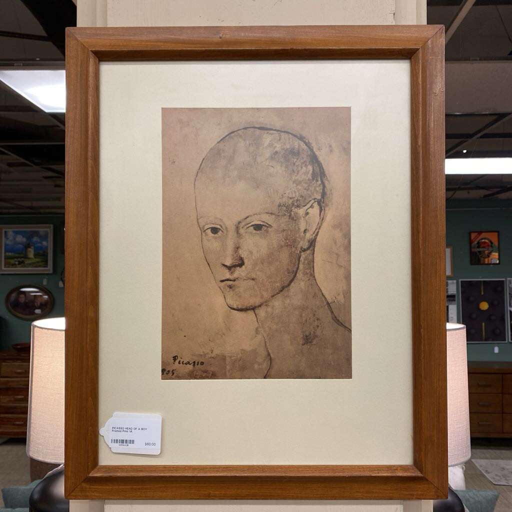 Framed artwork of a classical portrait with a wooden frame, displayed indoors.