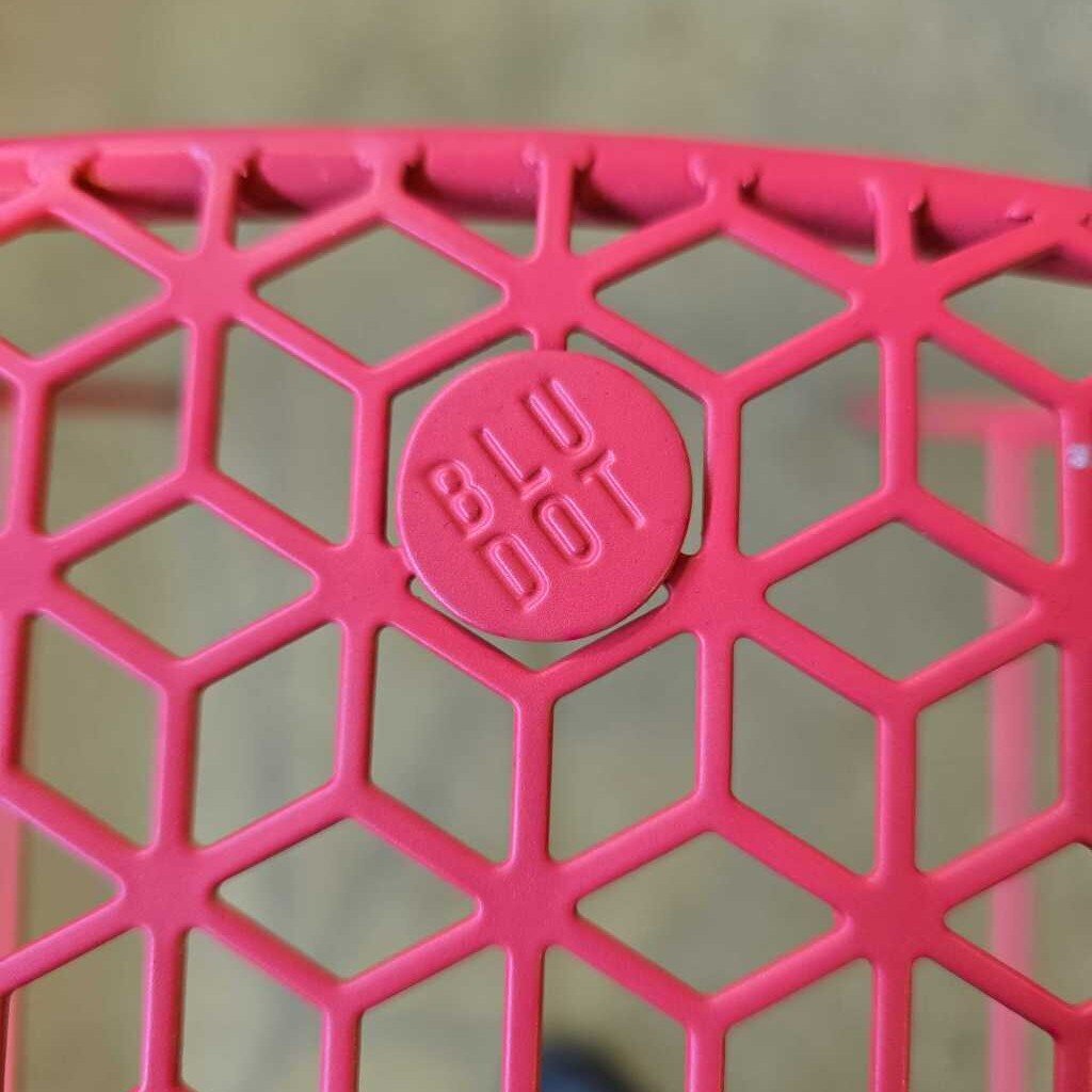 Close-up of a pink textured object with 'BLU DOT' logo.