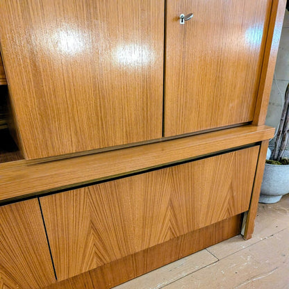 Wooden cabinet with two doors on a wooden floor.