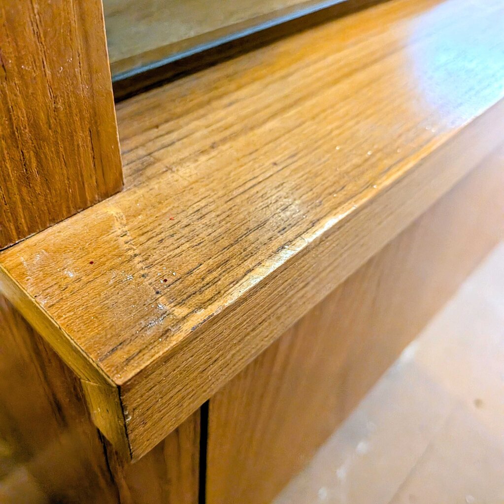 Close-up of a wooden surface with a reflective top
