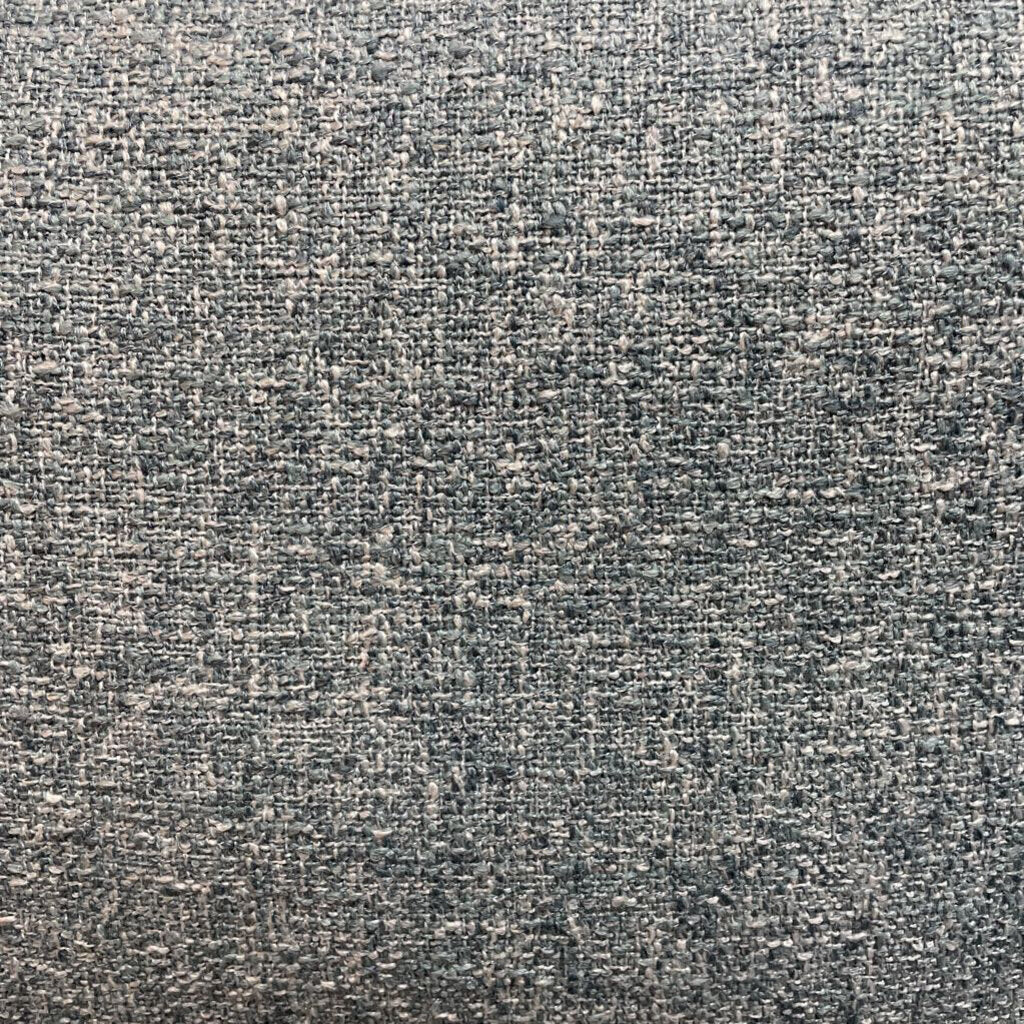 A light grey textured fabric sectional sofa featuring a left-arm-facing chaise with button-tufted seat cushions, two matching bolster pillows, and tapered wooden legs.