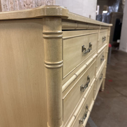 Beige dresser with decorative columns in a room setting