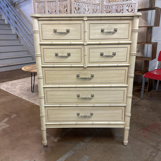 Beige bamboo-style dresser with multiple drawers in a room setting.