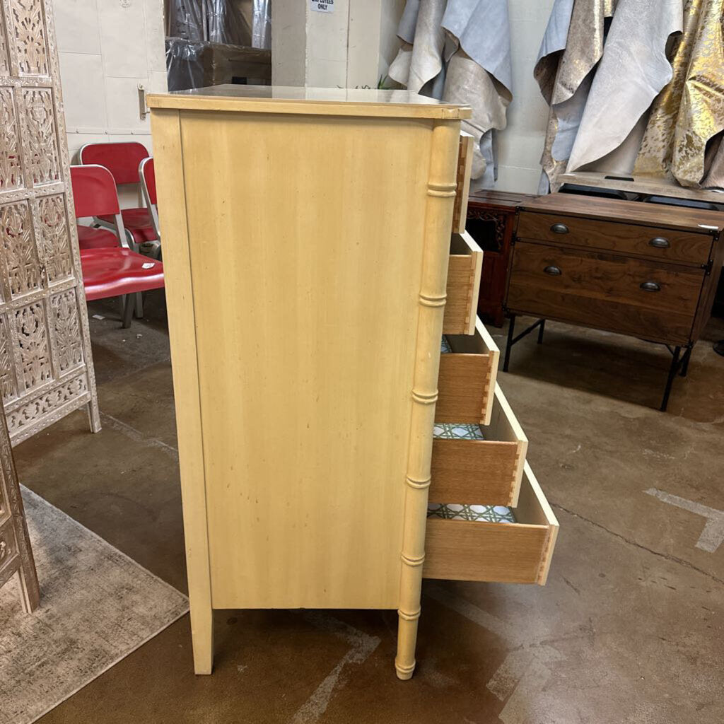 Light wooden dresser with open drawer in a store setting