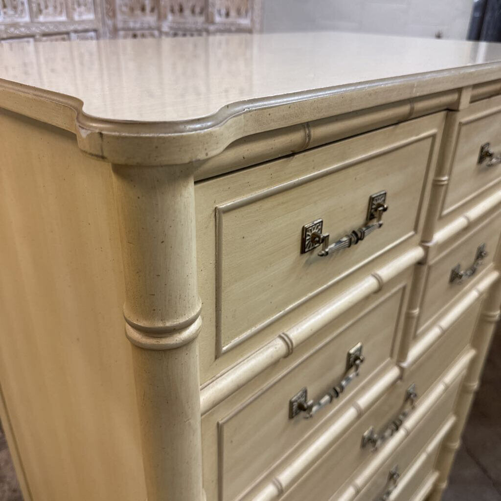 Beige dresser with metallic handles in a room setting