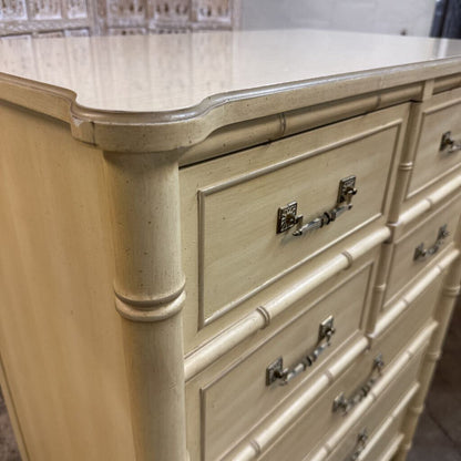 Beige dresser with metallic handles in a room setting