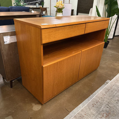 Wooden sideboard with drawers and doors in a room setting