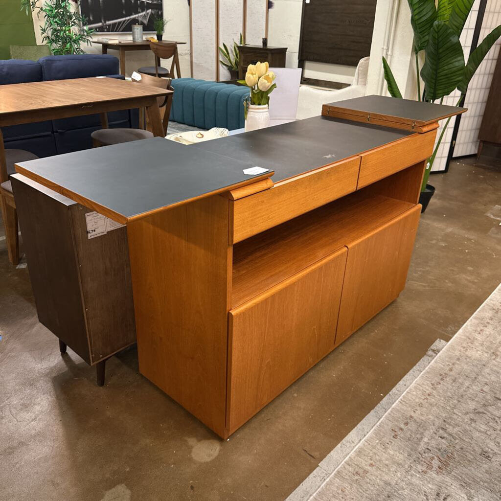 Wooden reception desk with a gray top in an indoor setting
