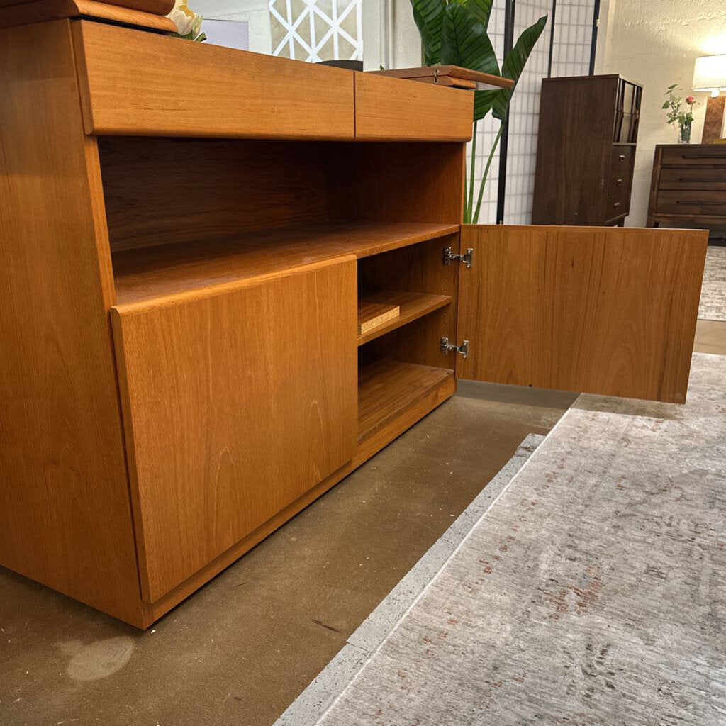 Wooden cabinet with open doors in a room setting