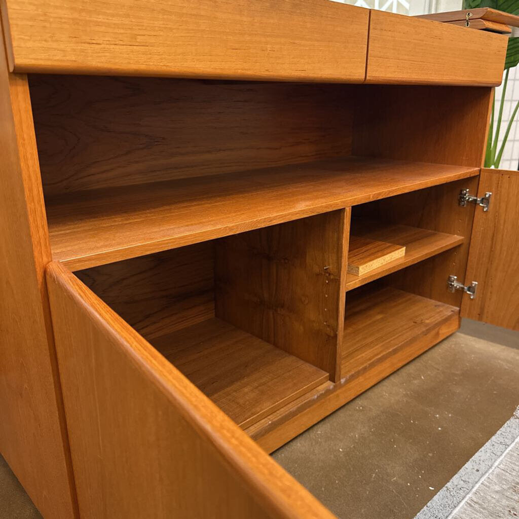 Wooden cabinet with open doors on a concrete floor