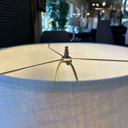 Close-up of a lampshade with a blurred indoor setting in the background