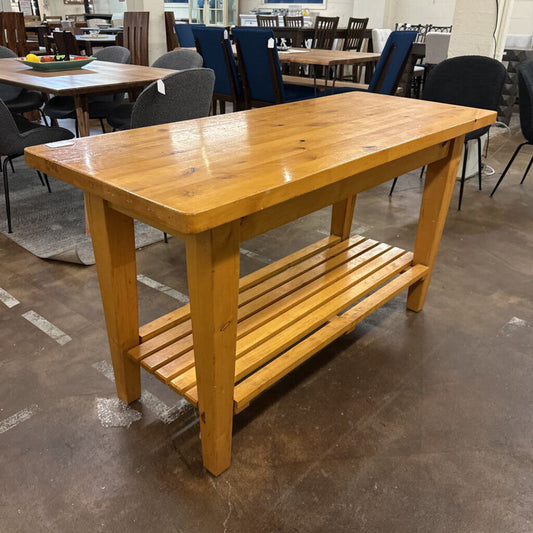 Wooden table with a shelf in an indoor setting