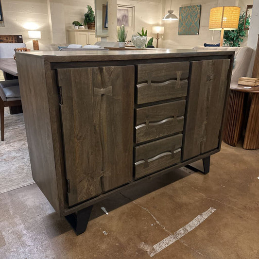 Wooden sideboard with drawers in a room setting