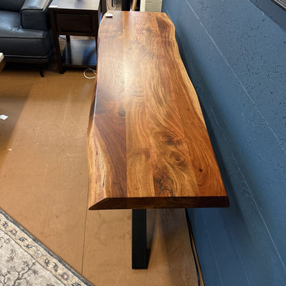 Wooden bench against a blue wall in an indoor setting