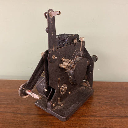 Vintage mechanical device on a wooden surface with a light green background