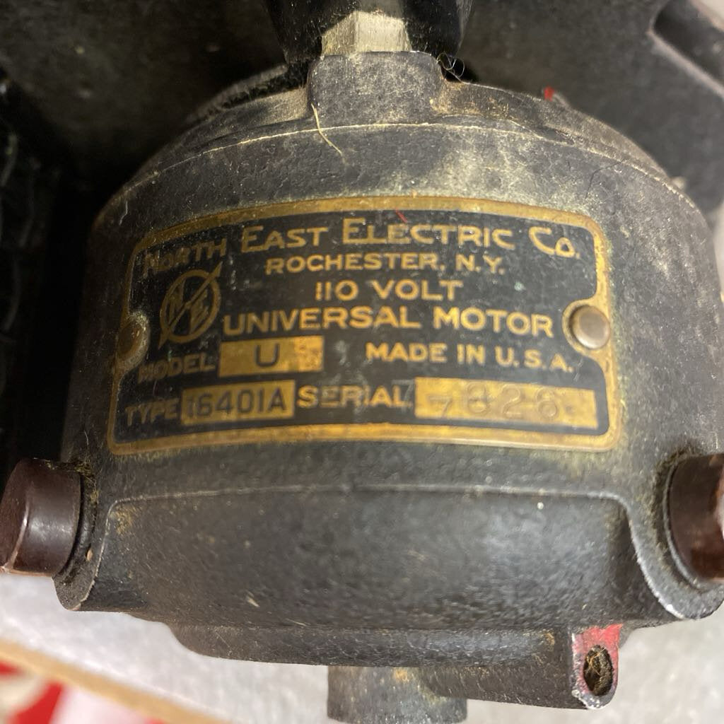 Vintage East Electric Co. universal motor with label on a dark background